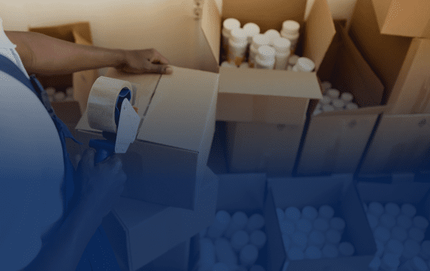Worker packing products in cardboard boxes