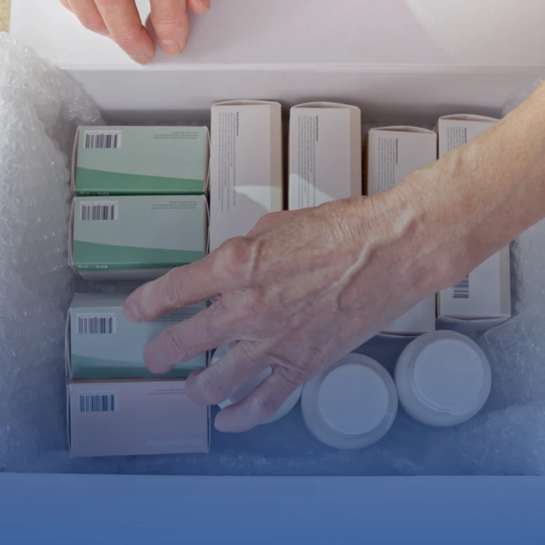 Person handling boxed and bottled medication supplies