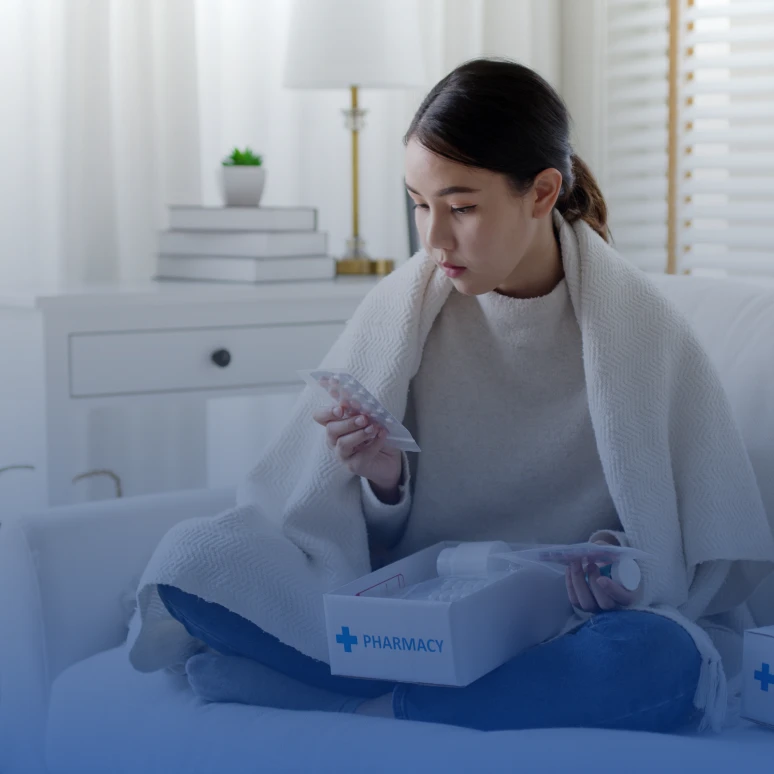 Woman holding pharmacy package indoors